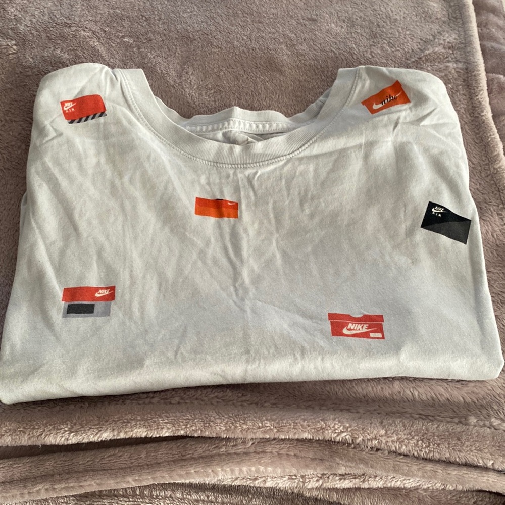 Light blue colored, Large Nike tee. Nike Shoe box deigns for the sneaker head.